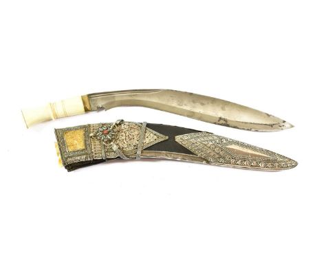 A Late 19th Century Nepalese Kukri, the 29cm curved steel blade with three narrow fullers to the back edge, with nickel bolst