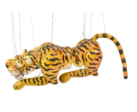 A Burmese Large Carved Wood Tiger Puppet, painted in black, white and yellow, with strung limbs, head, lower jaw, body and ta