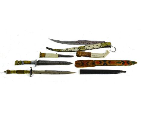 An Inuit Bone Knife, the 7cm single edge steel blade with oblong bone grip with stained band, the two piece bone scabbard inc