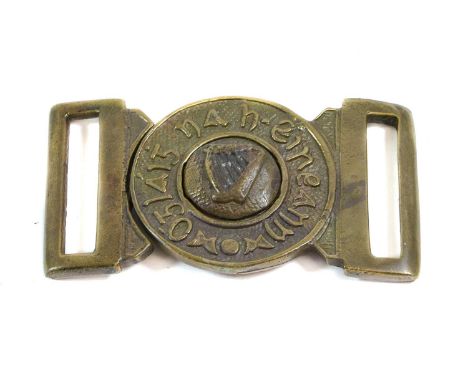 An Irish Brass Belt Buckle, cast with a harp within a border inscribed Oglaigh na Eireann (Soldiers of Ireland), the reverse 