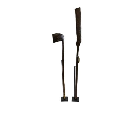 Two Karamojong Dance Staffs, Kenya, one of angular gunstock form on a cylindrical haft and splayed butt, the other of axe for