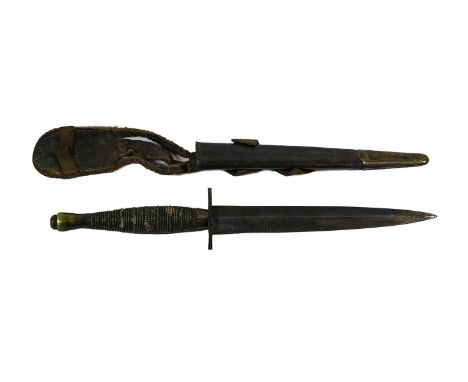 A Second World War Commando Knife, with 17.5cm machine forged blued steel blade, blued steel oval crossguard, the brass beade