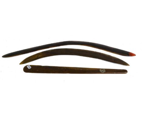 A 19th Century Australian Aboriginal Hunting Stick (Boomerang), each slightly convex side with adzed decoration, one tip pain