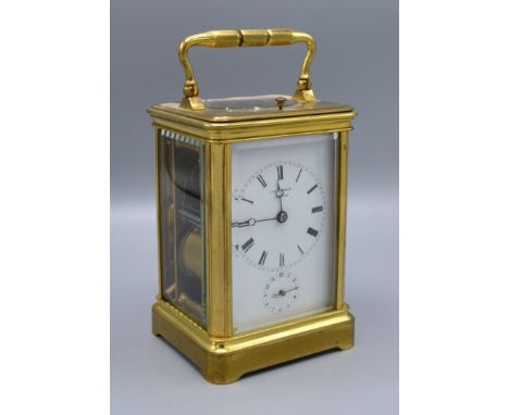 A Brass Carriage Clock by J W Benson, London, the enamel dial with Roman numerals and subsidiary alarms dial with lever escap