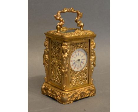A Miniature Brass Cased Carriage Clock of Rococo form the enamel dial with roman numerals, with lever escapement and carrying