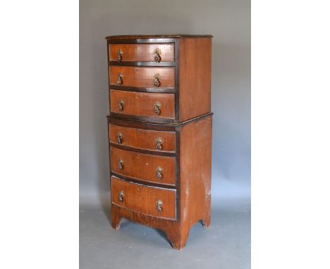 An Early 20th Century Mahogany Bow-fronted Chest on Chest with an arrangement of six drawers with brass drop handles raised u