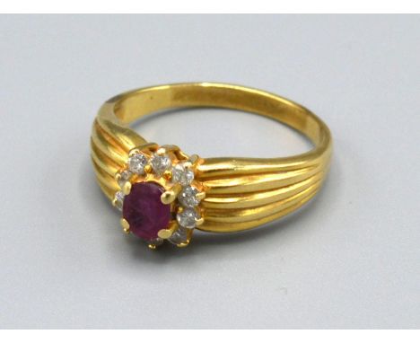 A tested 18ct Yellow Gold Ruby and Diamond Ring set with central ruby surrounded by diamonds within a pierced setting, Size P