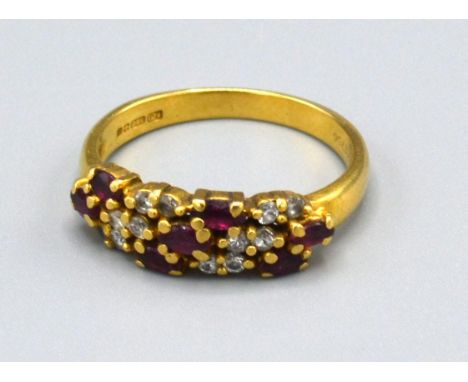 A 18ct Yellow Gold Diamond and Ruby Ring set with three rows of rubies interspersed with diamonds, Size N, 3.5 grams 