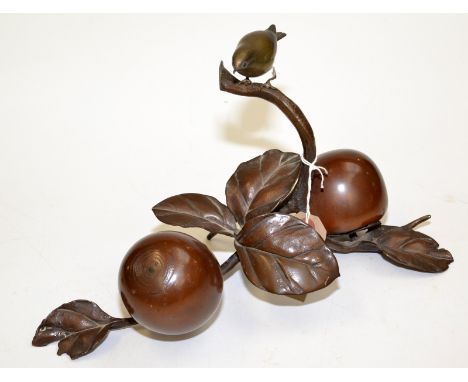 An oriental bronze of a sparrow on a branch above a pair of persimmon and leaves, width 35cm, height 19.5cm.