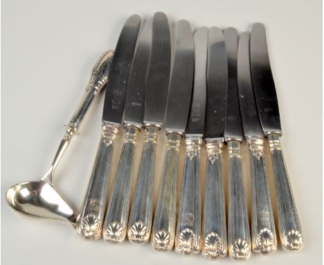 A set of four German dinner knives with filled handles, five German knives with silver plated handles and a German ladle. 