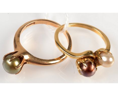 An 18ct. gold ring crossover set with pearls and a 14ct. gold ring set with a black pearl, 6.9g.