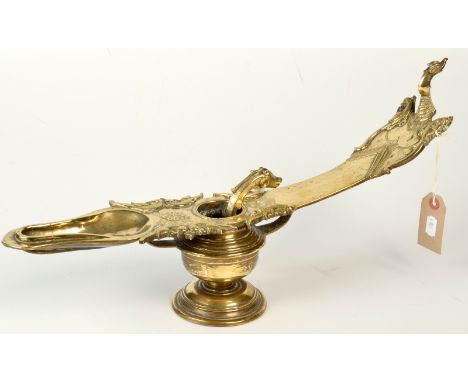 A Burmese polished bronze oil lamp cast to one end with a fabulous bird, to both sides with preening birds and with a central