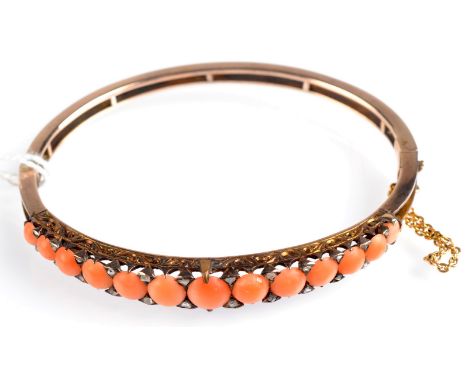 A Victorian coral and diamond gold bangle in a retailers case of Richard Attenborough, Oxford Street.  Condition Report: This