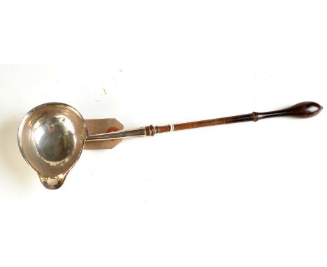 A George III punch ladle with turned wood handle.