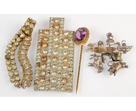 A Victorian stick pin in a leather covered case, together with silver charms etc. 
