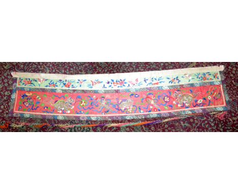 A Chinese first half of the 19th century silk panel decorated with Daoist symbols and dogs of Fo, 182 x 39cm.