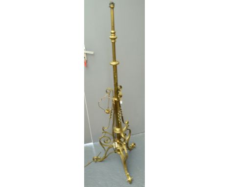 A late Victorian ornate brass adjustable standard lamp, wired. 