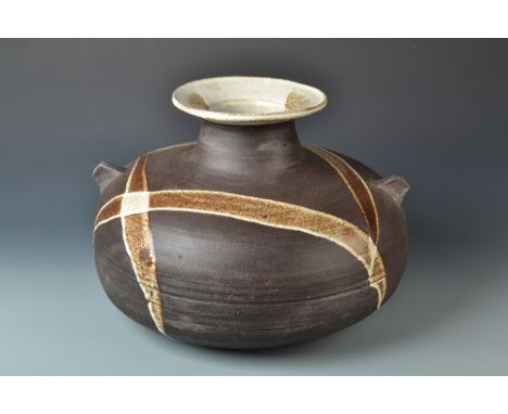 A monumental Janet Leach stoneware vase the iron body with four poured glaze trails and twin lug handles. Pottery and persona