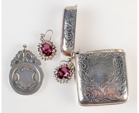 Amethyst earrings, a silver coloured metal vesta case and a silver medal. 