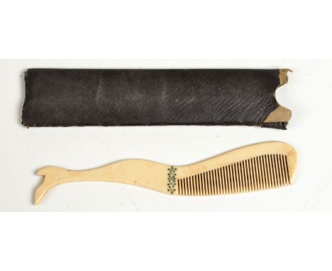 A Victorian bone moustache comb made as a ladies leg with paste stone garter, length 13.5cm, original leather sleeve.