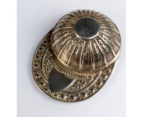 A replica jockey's cap caddy spoon. 