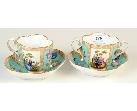 A pair of Meissen style quatrefoil, twin handled, cups and saucers. Crossed swords and 'W' marks. Condition Report: Damage, o