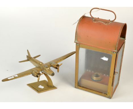 A brass model of a WWII twin engine bomber, wing span 35cm. and a brass companion way lamp.
