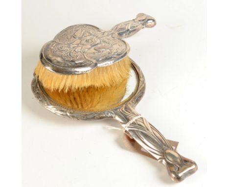 An Art Nouveau hand mirror the back with wading herons together with a matching brush. 