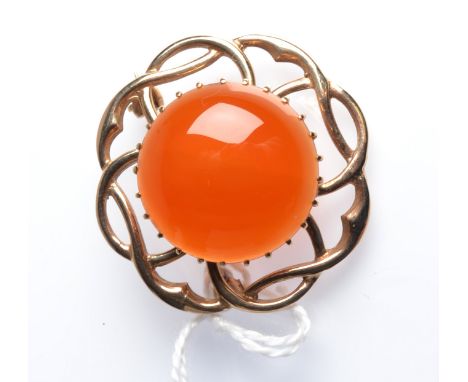 A 9ct. gold Celtic style brooch set with a central circular carnelian cabochon, diameter 3.2cm.