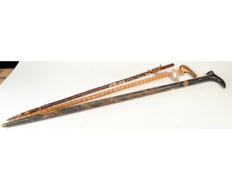 A swordstick, one other walking stick and an Alpen stick. 