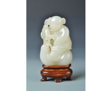 A Chinese 18th century pale celadon jade figure of a youth standing upon a large double gourd and holding a gourd, height 5.2