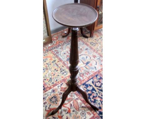 A fluted and turned mahogany plant stand on a tripod base, 