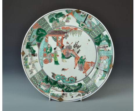 A Chinese 19th century Kangxi bowl painted to the edge with scenes from a story about a central panel of male and female figu