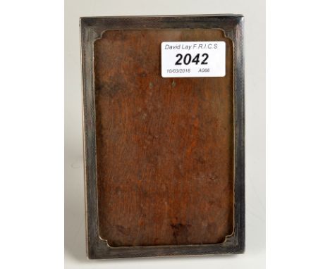 An engine turned, silver, photograph frame. Condition Report: Birmingham 1927. One corner a little dented. It stands. All ori