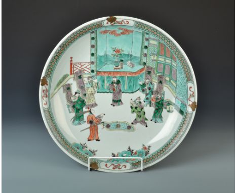 A Chinese 19th century Kangxi bowl painted with a ceremonial scene of dignatories and a warrior, standing before an altar wit