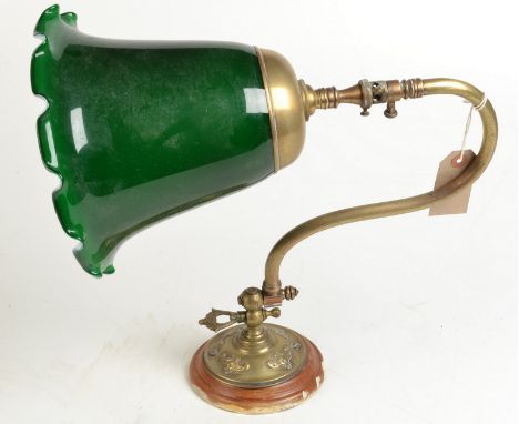 A wall lamp with green glass shade.