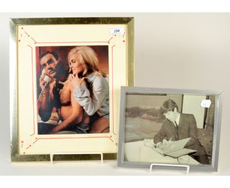 A publicity transparency print of Sean Connery and Shirley Eaton in Goldfinger and a photograph of Paul McCartney writing.