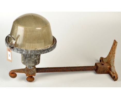 An exterior lamp on a cast iron bracket.