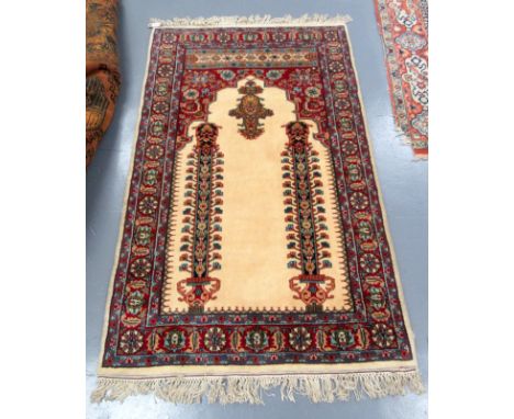 An Indian Jaipur prayer rug, the ivory mihrab with central hanging lamp flanked by columns, with original receipt, purchased 