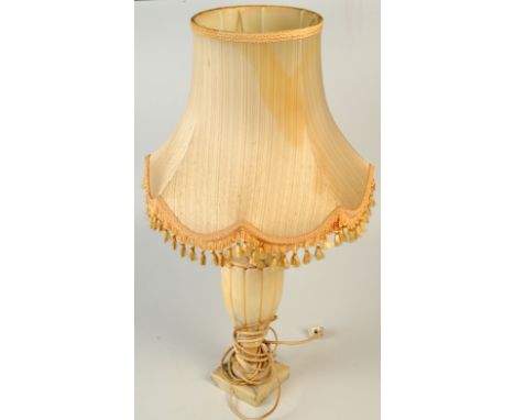 An alabaster, urn shape table lamp with shade. 