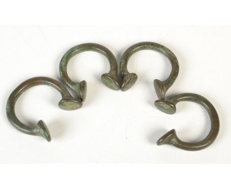 Four bronze slave manillas.