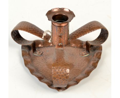 A Hayle, J. & F.Pool Copper chamber stick with lobed triangular base. No. 6769 in makers catalogue. Height 9cm, width 14cm. 