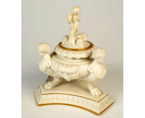 A 19th century Parian tripod ink well, heightened with gilding, the lid with a figure of cupid, maximum height 15cm.   Condit