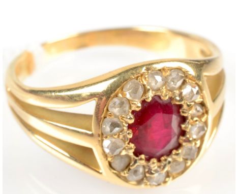 A high purity gold ring with an oval ruby surrounded by diamonds and with pierced shoulders.
 Condition Report: Some surface 