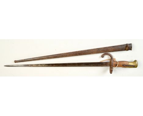 A French St. Etienne 1879 sword bayonet with a brass and hardwood handle, metal scabbard, full length 66cm. 