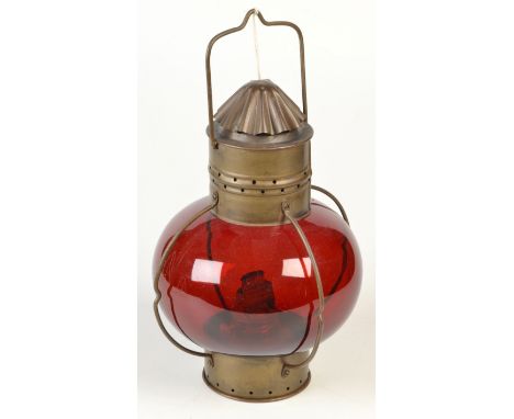 A ship's brass and red glass lamp, height 30cm.