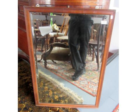 A mirror with bevelled glass in a moulded mahogany frame, size including frame 64.7 x 95cm.