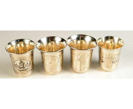 Four small Russian silver cups, each with engraved decoration, one with Niello enamelled architecture, average height 4.7cm, 