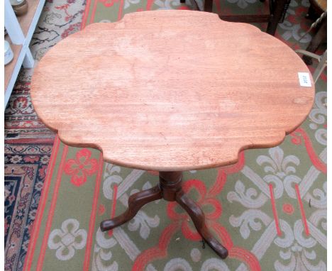 An oval mahogany tripod wine table.