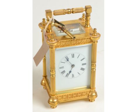 An ornate brass chiming carriage clock with pillar corners, height 16cm. Condition Report: Replacement lever escapement, no g